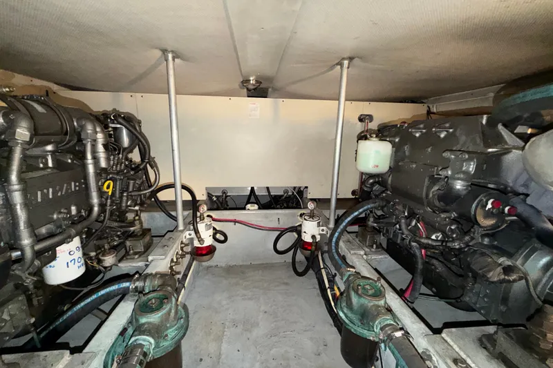Slide: The Image of Engine room of 2006 Mainship 34 Trawler, showcasing dual engines and mechanical components. - 27
