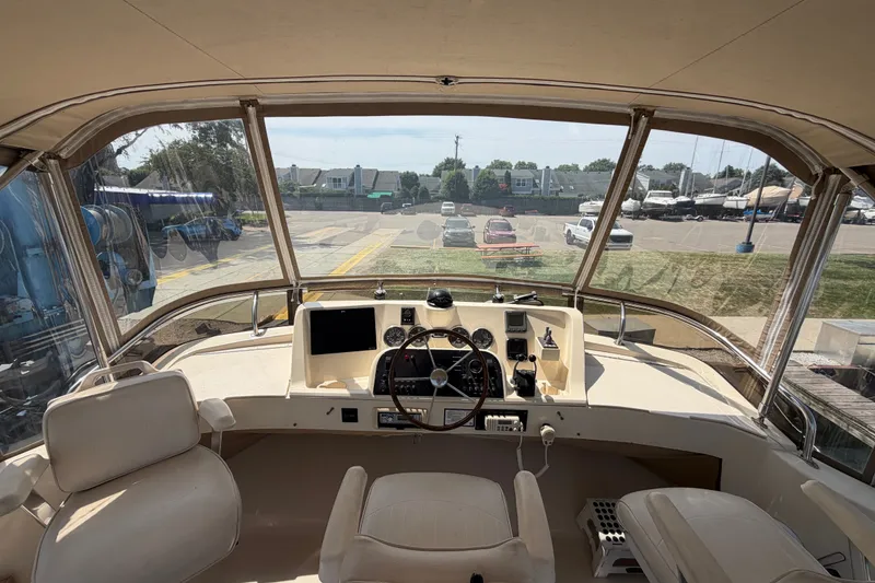 Slide: The Image of Interior view of 2006 Mainship 34 Trawler helm with steering wheel and navigation instruments. - 50