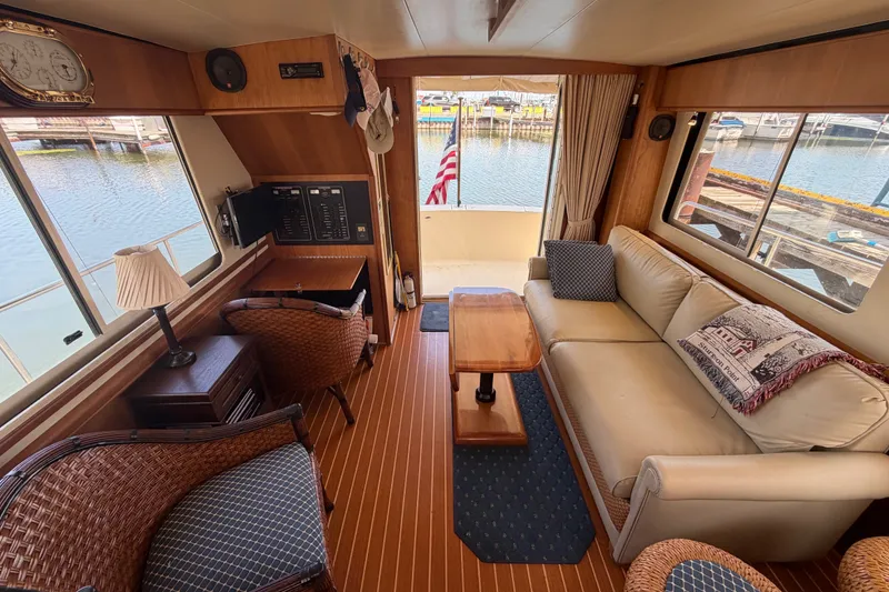 Slide: The Image of Interior of 2006 Mainship 34 Trawler with cozy seating and wooden decor. - 81