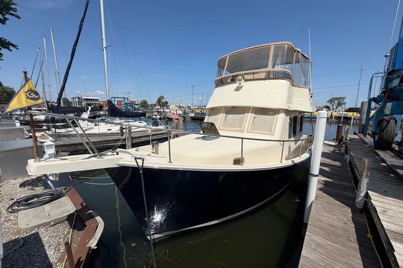 Slide: The Image of 2006 Mainship 34 Trawler docked at marina under clear blue sky. - 5