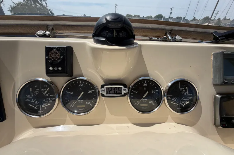 Slide: The Image of Dashboard of a 2006 Mainship 34 Trawler with gauges and compass. - 54