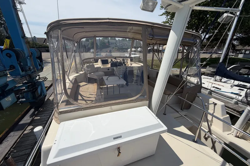Slide: The Image of 2006 Mainship 34 Trawler with enclosed cockpit, docked at marina. - 43