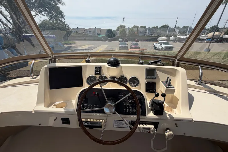 Slide: The Image of 2006 Mainship 34 Trawler helm with steering wheel, gauges, and navigation equipment. - 51