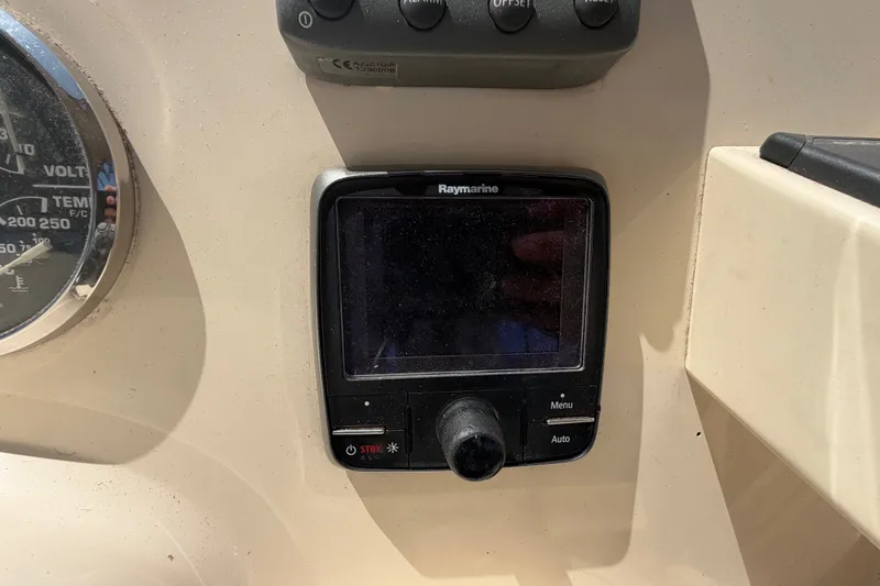 Slide: The Image of Control panel of a 2006 Mainship 34 Trawler featuring a Raymarine display. - 56