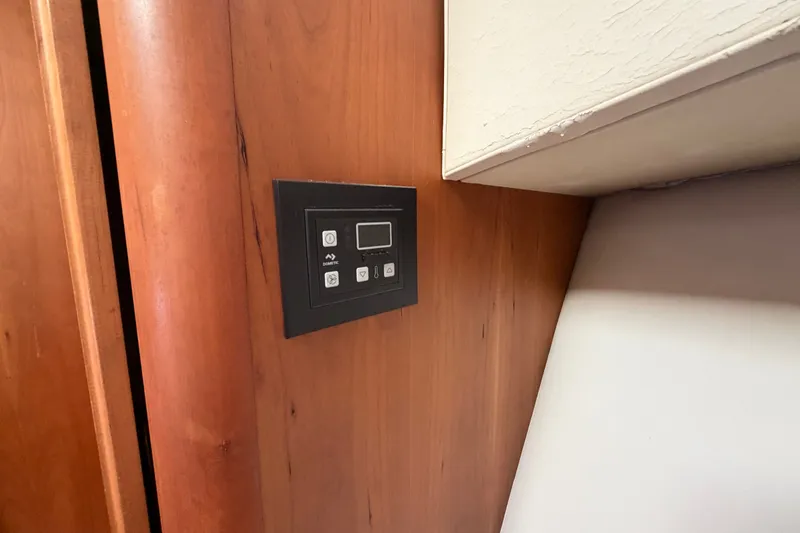 Slide: The Image of Control panel on 2006 Mainship 34 Trawler's wooden interior wall. - 91