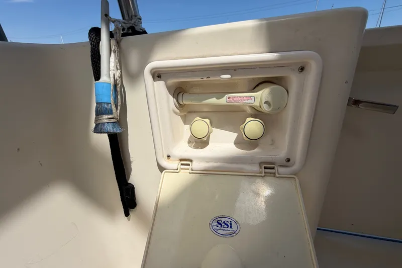 Slide: The Image of 2006 Mainship 34 Trawler deck detail with cleaning brush and utility compartment. - 15
