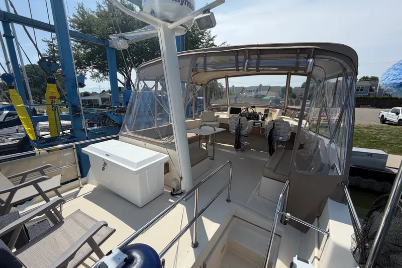 Slide: The Image of 2006 Mainship 34 Trawler with spacious deck and seating area, docked at marina. - 41