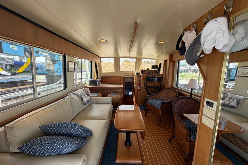 Slide: The Image of Interior of 2006 Mainship 34 Trawler with cozy seating and wooden accents. - 65