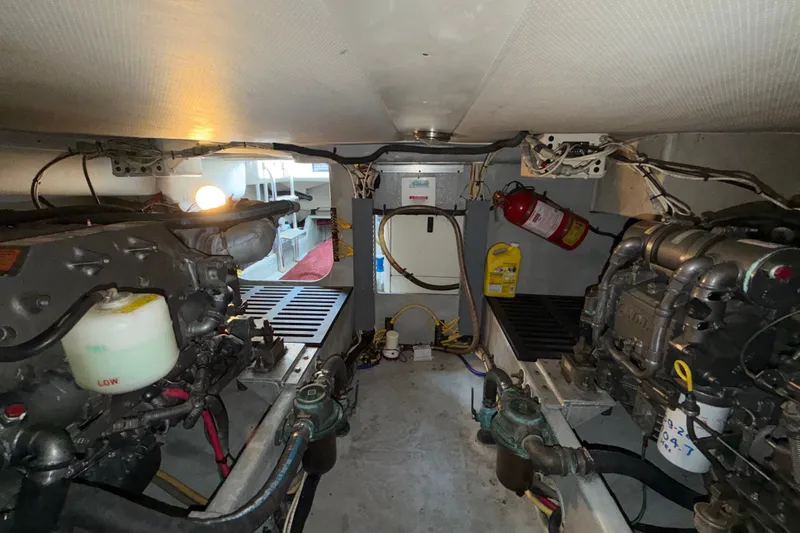 Slide: The Image of Engine room of 2006 Mainship 34 Trawler, featuring dual engines and safety equipment. - 32
