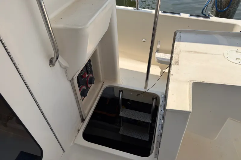 Slide: The Image of 2006 Mainship 34 Trawler cockpit with access hatch and control panel. - 17