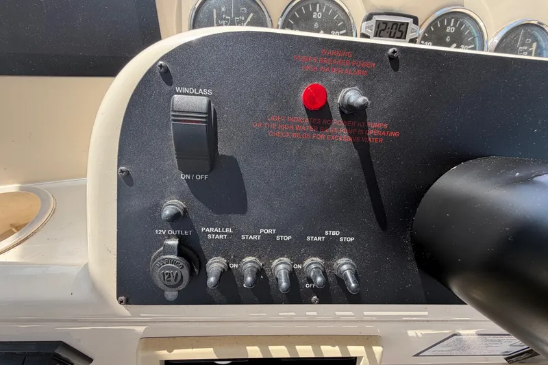Slide: The Image of Control panel of a 2006 Mainship 34 Trawler with switches and gauges. - 58