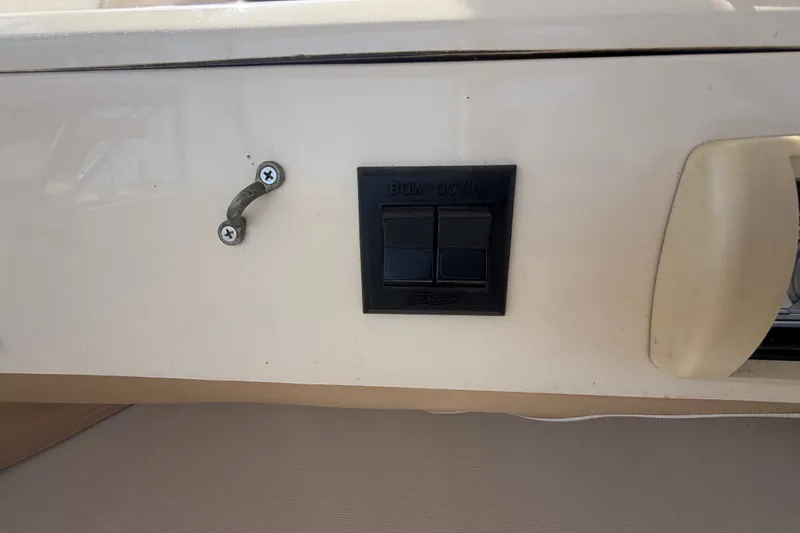 Slide: The Image of Control panel on 2006 Mainship 34 Trawler boat, featuring bow down switches. - 60