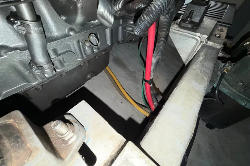 Slide: The Image of Engine compartment of a 2006 Mainship 34 Trawler with visible wiring and components. - 35