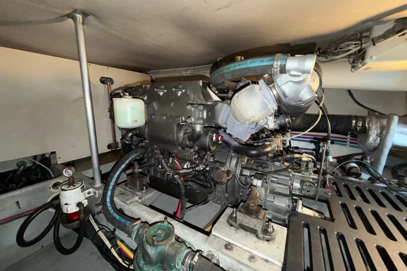 Slide: The Image of Engine room of a 2006 Mainship 34 Trawler, showcasing mechanical components and piping. - 29