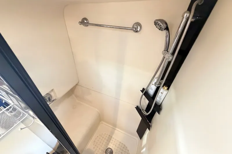 Slide: The Image of Shower area in 2006 Mainship 34 Trawler, featuring modern fixtures and storage. - 95