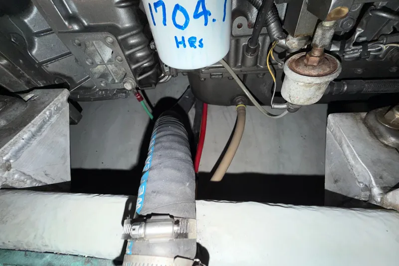 Slide: The Image of Engine compartment of a 2006 Mainship 34 Trawler, showing hoses and components. - 36