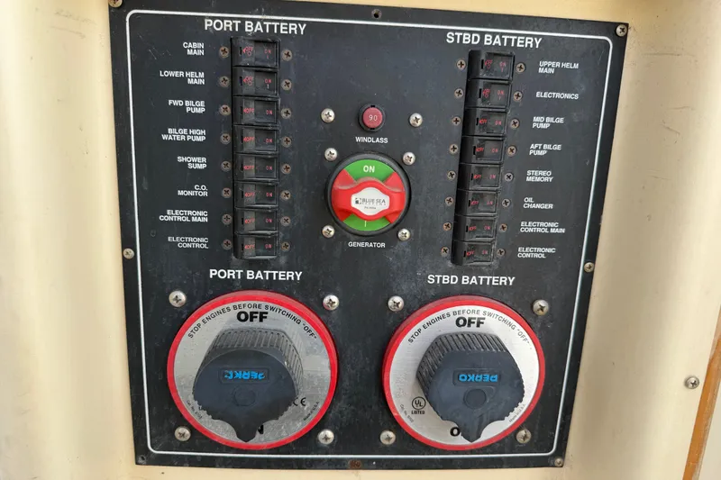 Slide: The Image of Control panel of a 2006 Mainship 34 Trawler, featuring battery switches and circuit breakers. - 18