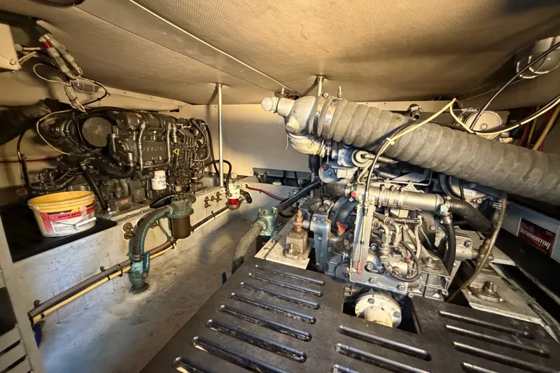 Slide: The Image of Engine room of 2006 Mainship 34 Trawler, showcasing mechanical components and systems. - 26