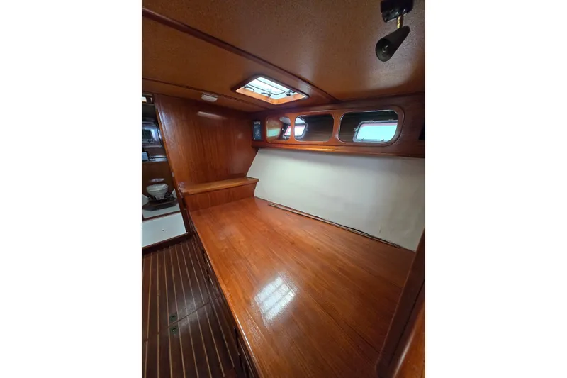 Slide: The Image of 1984 Raymond Hunt Sport Fisher cabin interior with wooden finish and porthole windows. - 10
