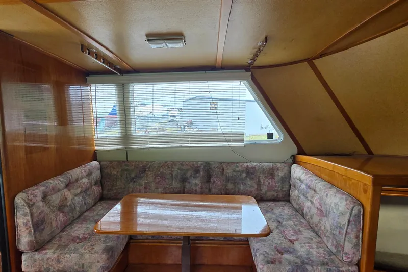 Slide: The Image of 1984 Raymond Hunt Sport Fisher interior with cozy dining area and floral upholstery. - 5