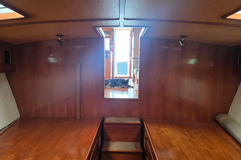 Slide: The Image of Interior of 1984 Raymond Hunt Sport Fisher boat with wooden finish and cozy atmosphere. - 14
