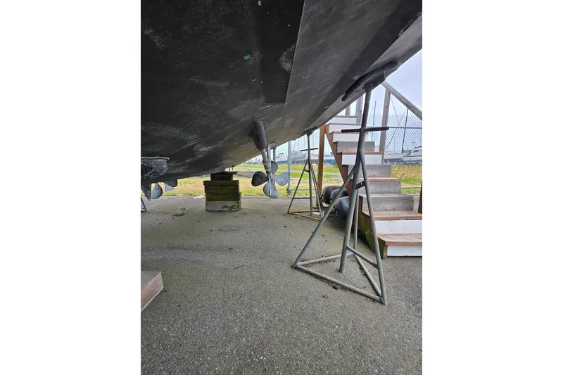 Slide: The Image of Underneath view of a 1984 Raymond Hunt Sport Fisher boat on stands. - 3