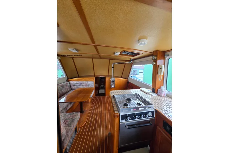 Slide: The Image of Interior of 1984 Raymond Hunt Sport Fisher with kitchen and seating area. - 4