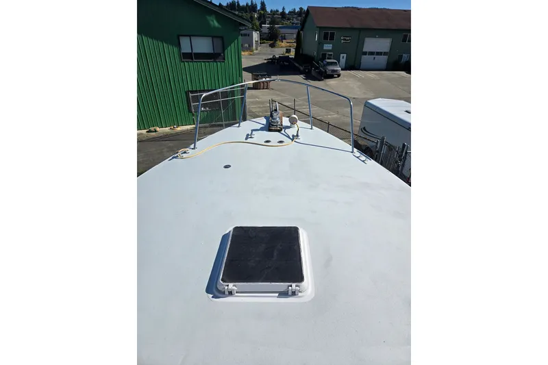 Slide: The Image of 1984 Raymond Hunt Sport Fisher boat deck in a marina setting. - 37