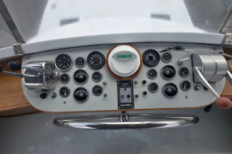 Slide: The Image of Control panel of a 1984 Raymond Hunt Sport Fisher boat with gauges and controls. - 29