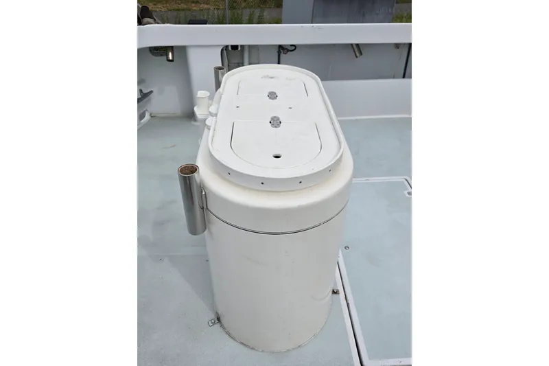 Slide: The Image of 1984 Raymond Hunt Sport Fisher boat deck with a white cylindrical storage unit. - 22