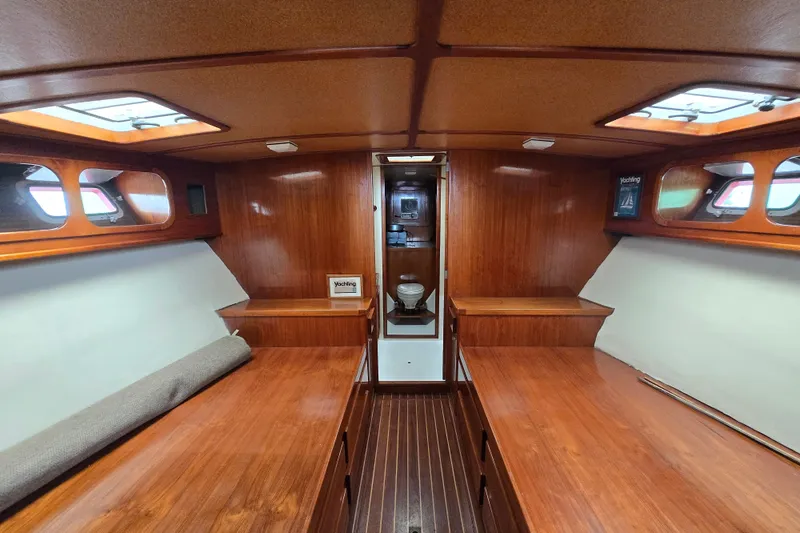 Slide: The Image of Interior of 1984 Raymond Hunt Sport Fisher boat with wooden finishes and seating area. - 32