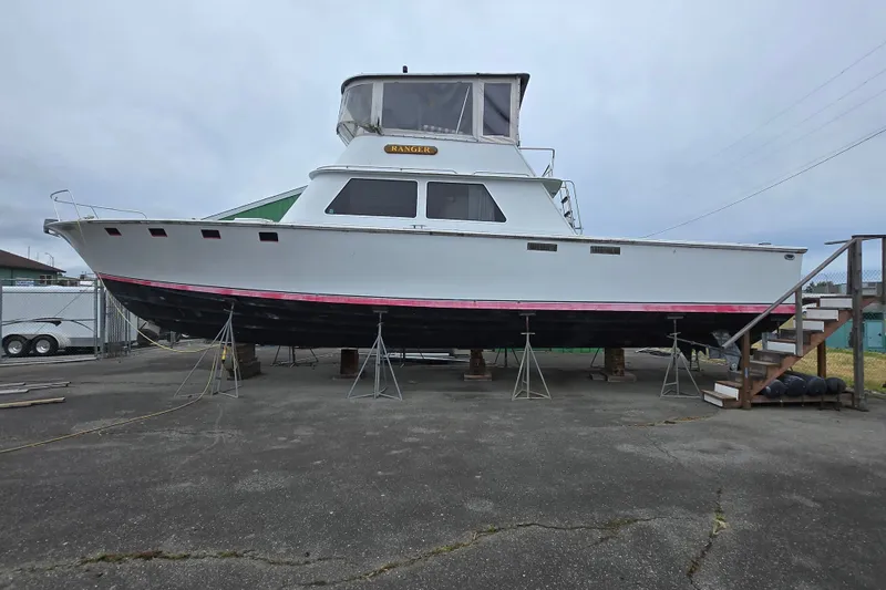 The Image of 1984 Raymond Hunt Sport Fisher boat on dry dock, side view. - 0