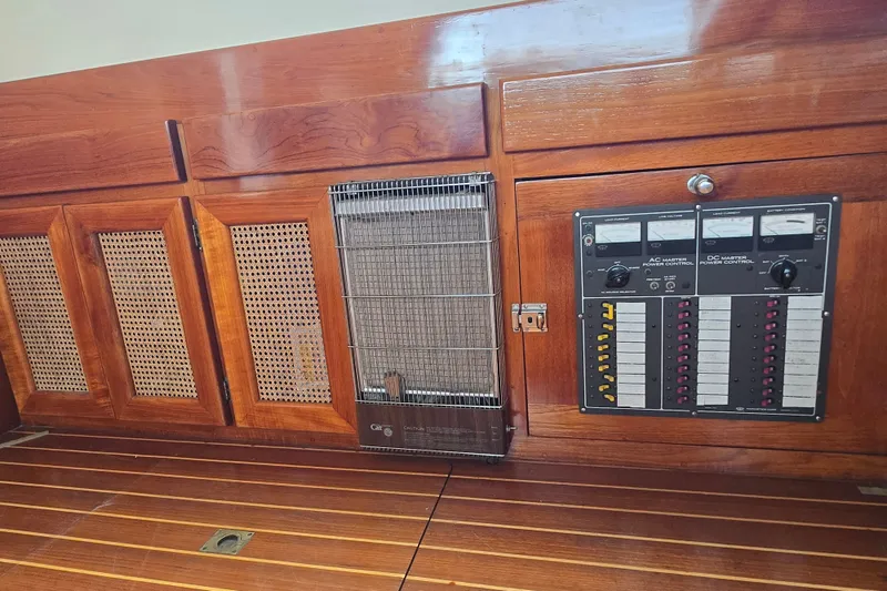 Slide: The Image of 1984 Raymond Hunt Sport Fisher interior with wooden paneling and control panel. - 8