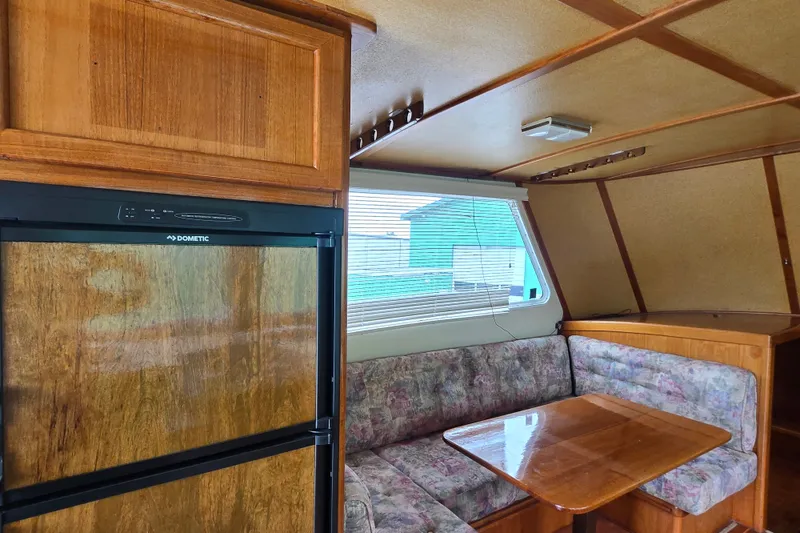 Slide: The Image of Interior of 1984 Raymond Hunt Sport Fisher with wood paneling and cozy seating area. - 7