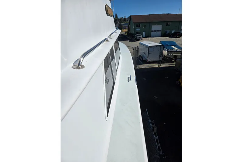 Slide: The Image of 1984 Raymond Hunt Sport Fisher boat, side view with railing and windows. - 38