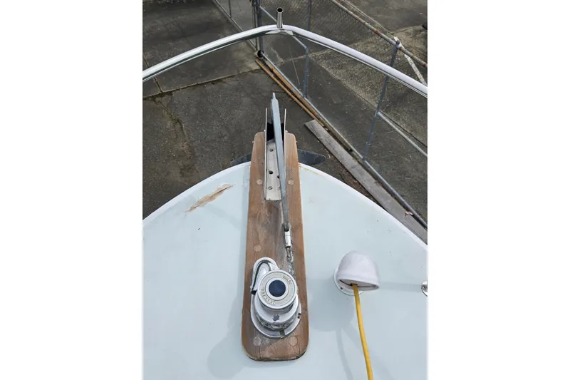 Slide: The Image of Bow of 1984 Raymond Hunt Sport Fisher with anchor mechanism and railing. - 33