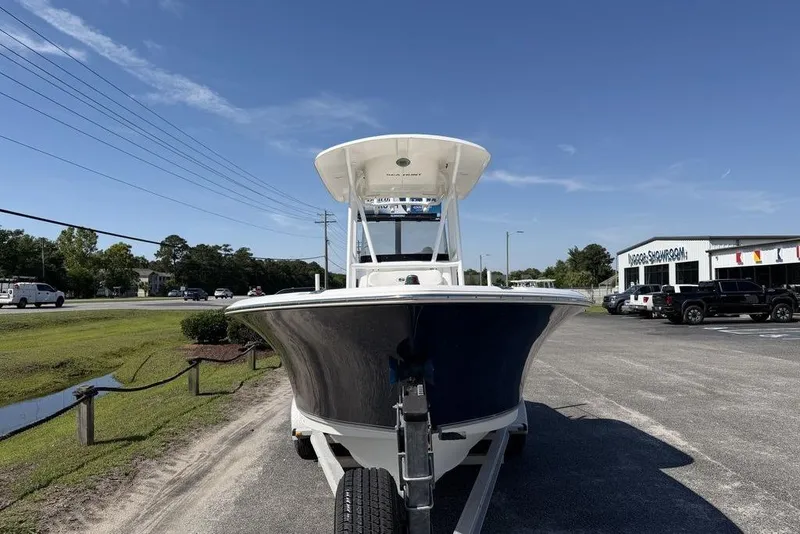 Slide: The Image of 2013 Sea Hunt Ultra 234 boat on trailer in parking lot, clear sky background. - 8