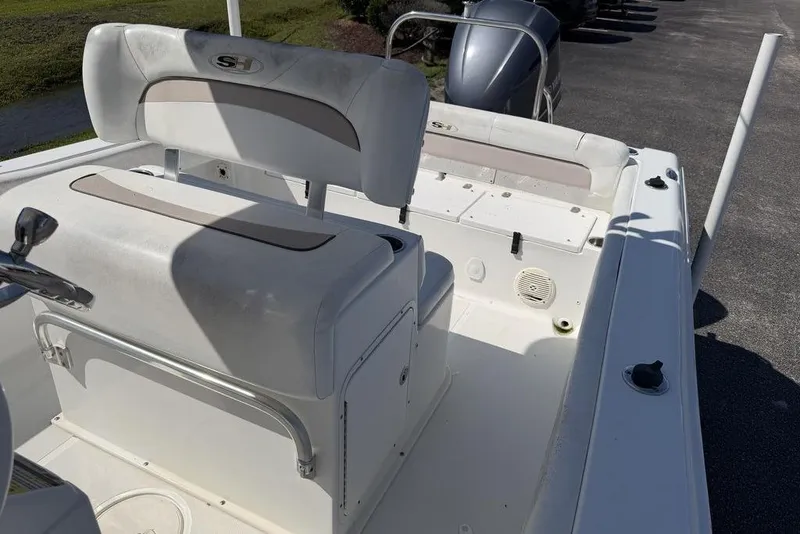 Slide: The Image of 2013 Sea Hunt Ultra 234 boat interior with seating and storage compartments. - 13