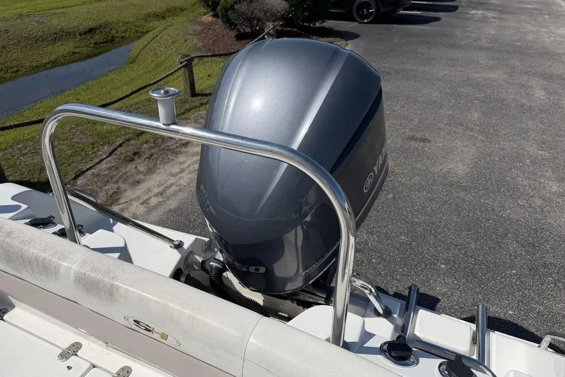 Slide: The Image of 2013 Sea Hunt Ultra 234 boat with Yamaha outboard motor, parked on pavement. - 15