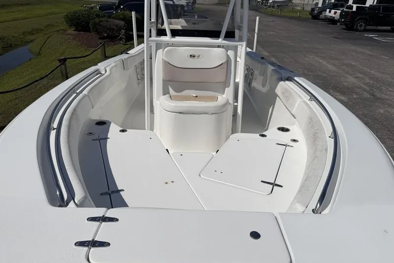Slide: The Image of 2013 Sea Hunt Ultra 234 boat interior with seating and storage compartments. - 16