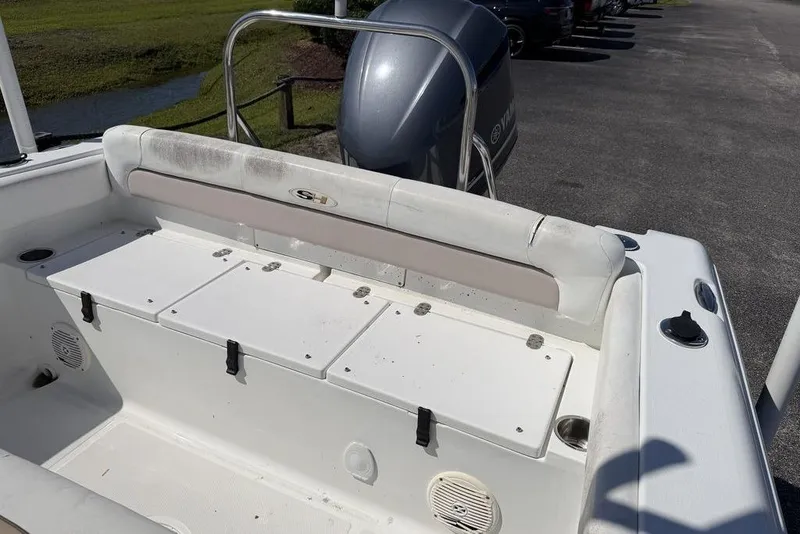 Slide: The Image of 2013 Sea Hunt Ultra 234 boat interior with storage compartments and Yamaha outboard motor. - 10