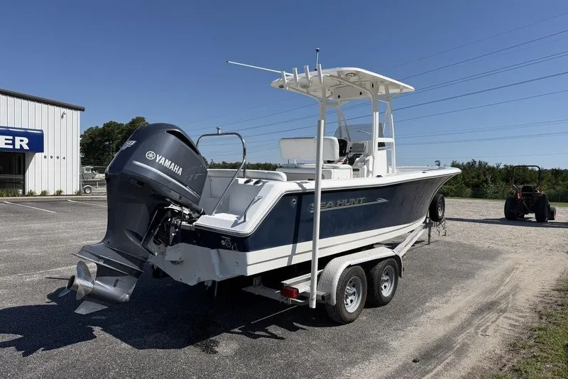 Slide: The Image of 2013 Sea Hunt Ultra 234 boat with Yamaha engine on trailer in sunny outdoor setting. - 7