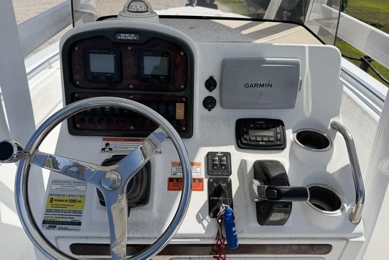 Slide: The Image of 2013 Sea Hunt Ultra 234 boat dashboard with Garmin navigation and steering wheel. - 9