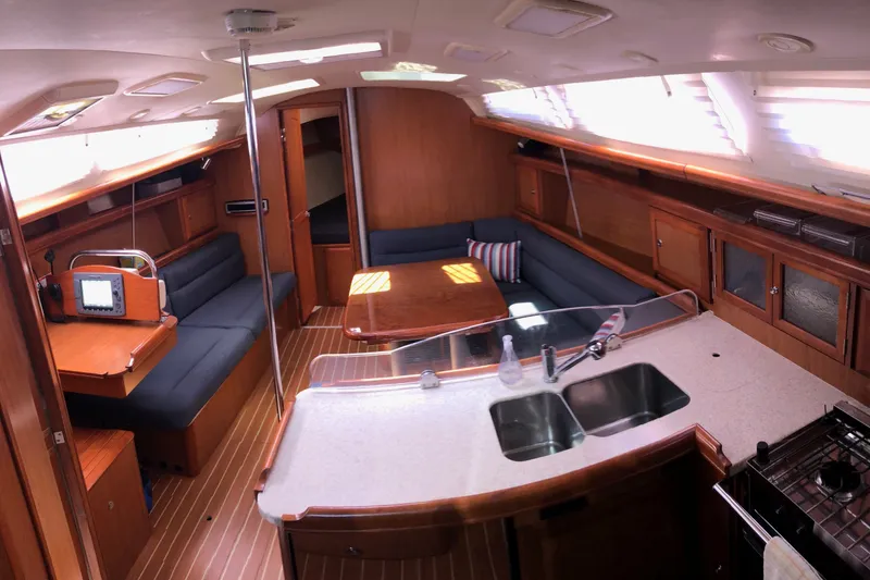 Slide: The Image of Interior of a 2008 Hunter 38 sailboat with spacious seating and modern kitchen amenities. - 2