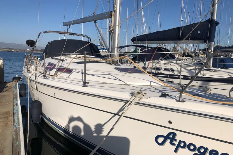 Slide: The Image of 2008 Hunter 38 sailboat docked at marina, clear sky, calm waters. - 16
