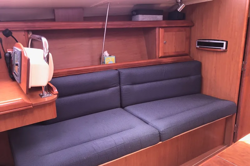 Slide: The Image of Interior of a 2008 Hunter 38 sailboat with a cozy seating area and wooden cabinetry. - 3