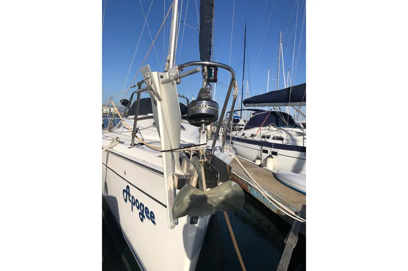 Slide: The Image of 2008 Hunter 38 sailboat docked, featuring anchor and marina setting. - 15