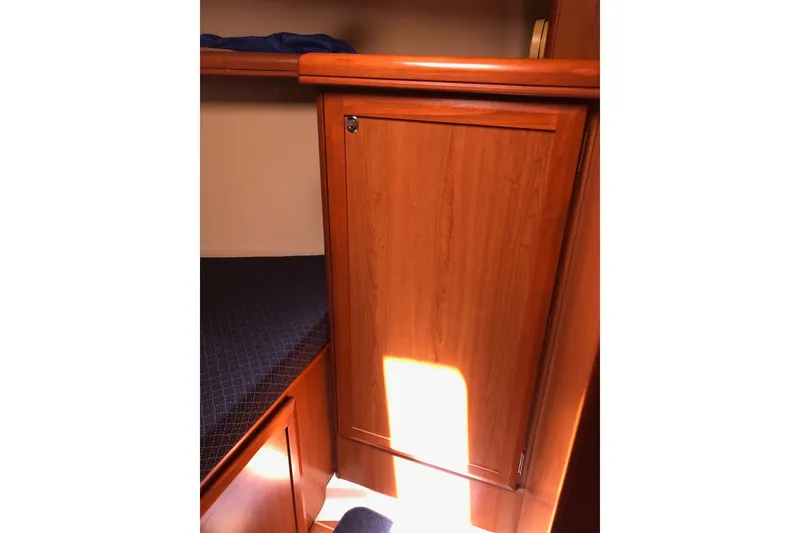 Slide: The Image of Interior cabin of 2008 Hunter 38 yacht with wooden cabinetry and bunk bed. - 10