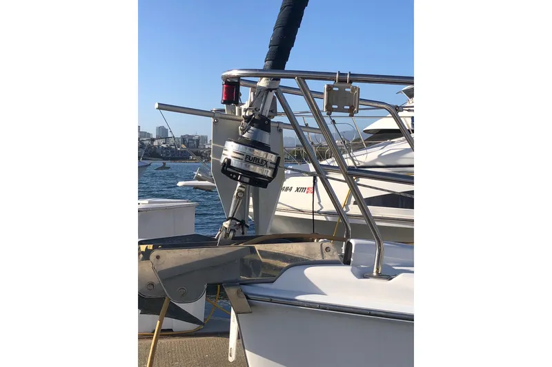 Slide: The Image of 2008 Hunter 38 sailboat with Furlex system, docked in a marina under clear blue skies. - 14