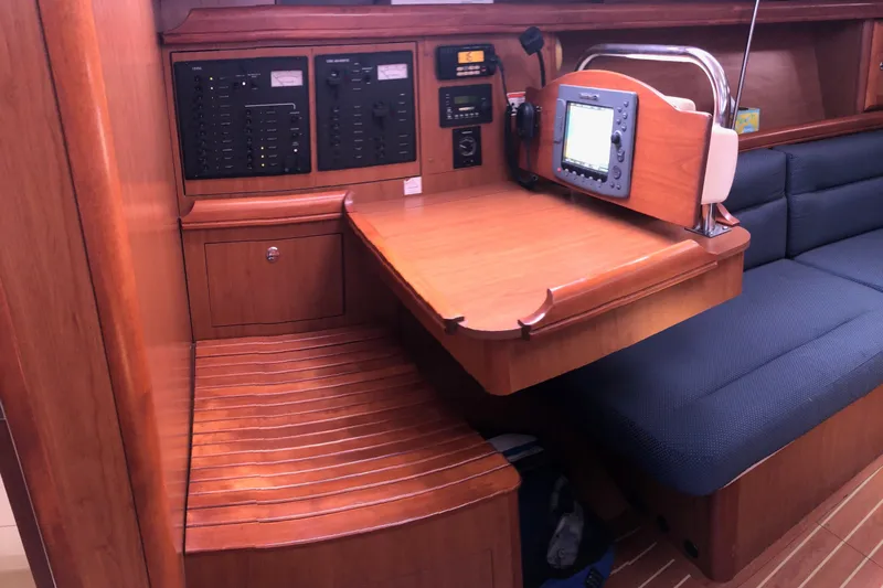 Slide: The Image of Navigation station in a 2008 Hunter 38 sailboat with control panels and seating. - 5